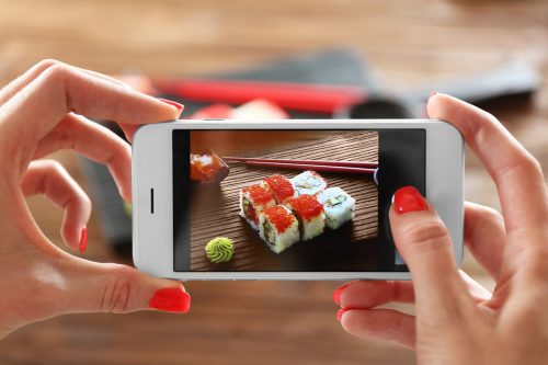 Woman,Taking,Photo,Of,Tasty,Sushi,Set