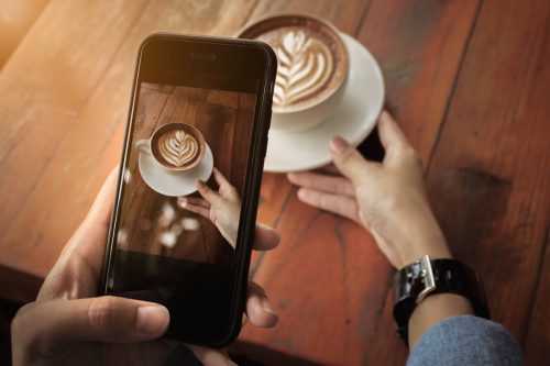 Young,Girl,Using,Photography,Of,Smartphone,Of,Latte,Art,Coffee
