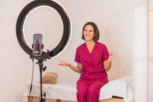 Smiling,Female,Doctor,Recording,A,Tutorial,Online,Using,A,Mobile