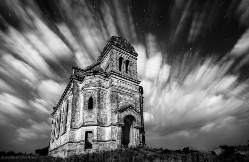The old church flying in stormy clouds